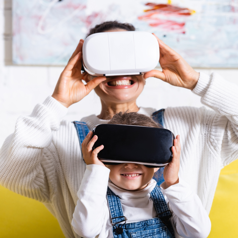A mother and child playing with VR headsets together.