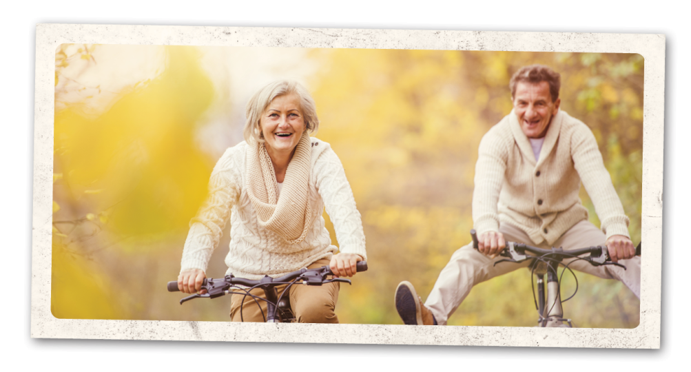 Elderly couple riding bicycles together.